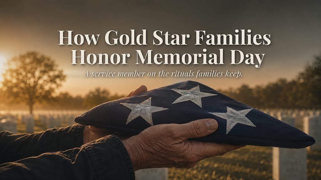 Two hands holding a folded American flag at a national cemetery on Memorial Day at dawn, white marble headstones soft-focus in the background, warm editorial light